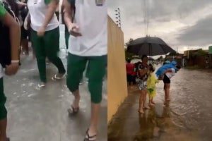 escola alaga e mães carregam alunos nas costas em rua coberta de água após forte chuva em Piracuruca