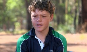 Jovem nadando em mar aberto, representando a coragem de Austin Appelbee para salvar sua família na Austrália.